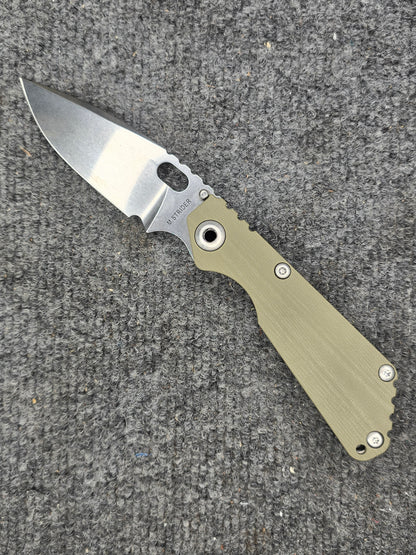Mick Strider SnG MagnaCut Folding Knife – Textured OD Green G10 & Anodized Titanium