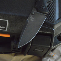 Bastinelli Creations Red IKBS Frame Lock Folding Knife 3.4" M390 Black PVD Stonewashed Drop Point Blade, Milled Black G10 Handle
